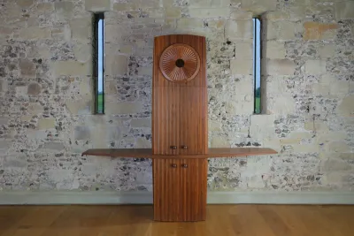 Cyclops cabinet in walnut, photographed in a Wiltshire barn
